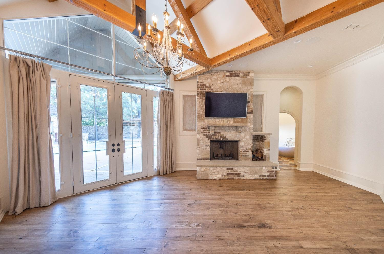 201 Juniper Drive Lamesa, TX 79331 - Photo 11 of 45 a view of a living room with fireplace a flat screen tv