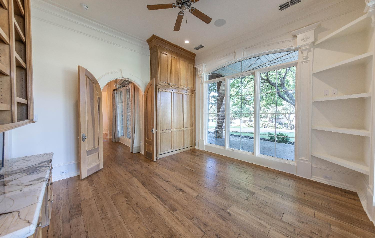 201 Juniper Drive Lamesa, TX 79331 - Photo 21 of 45 wooden floor in an empty room with a window