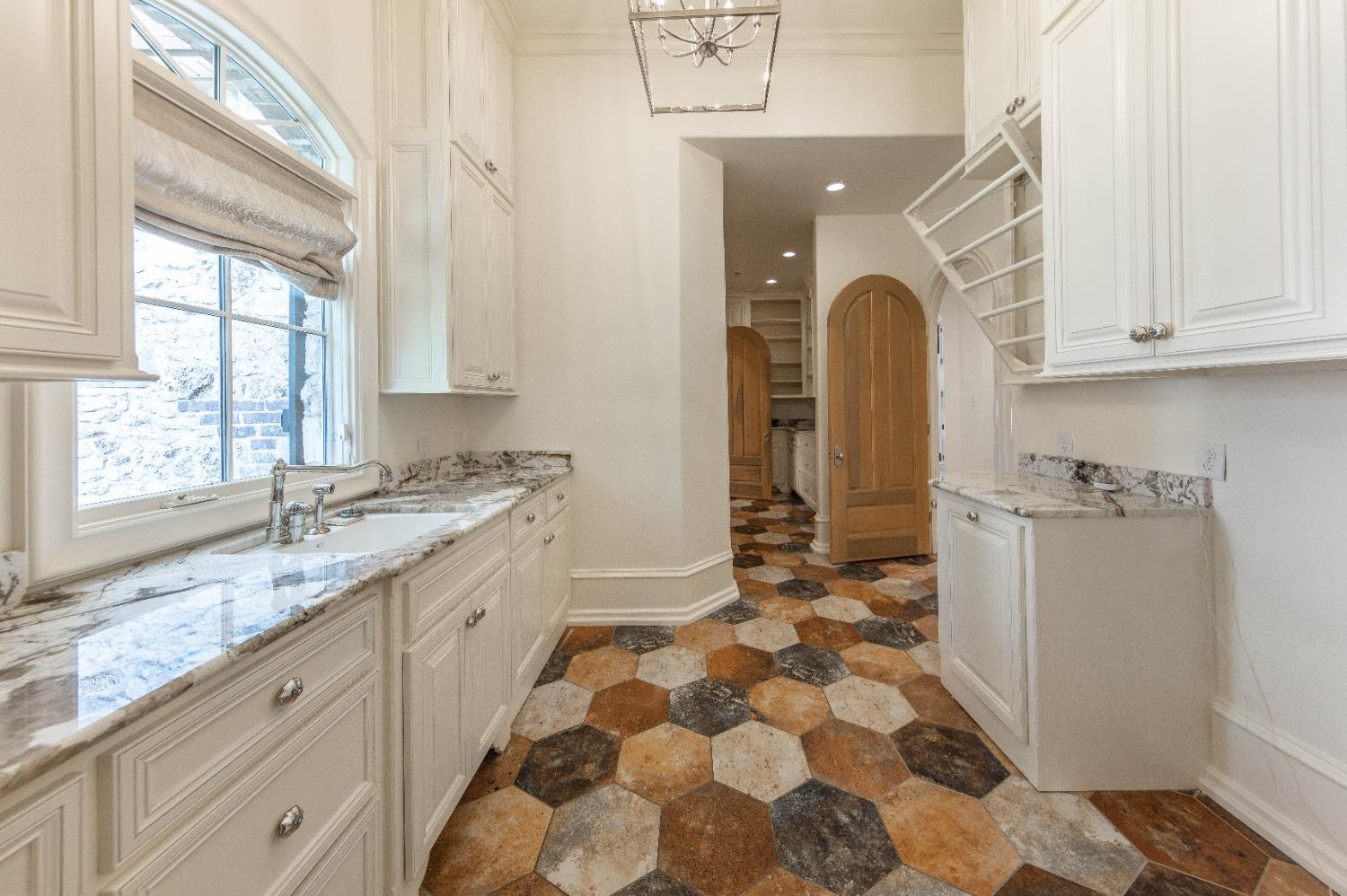 201 Juniper Drive Lamesa, TX 79331 - Photo 26 of 45 a bathroom with a granite countertop sink a toilet and a window