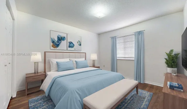 a bedroom with a bed and a potted plant