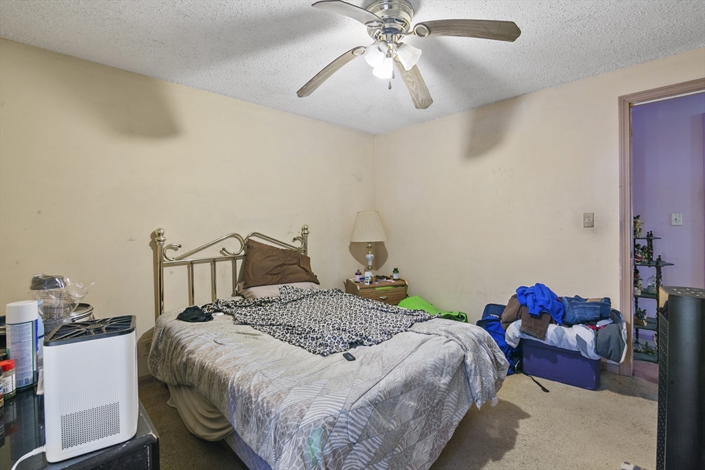 110 Tilton Street Springfield, MA 01109 - Photo 11 of 23 a bedroom with a bed and a chandelier