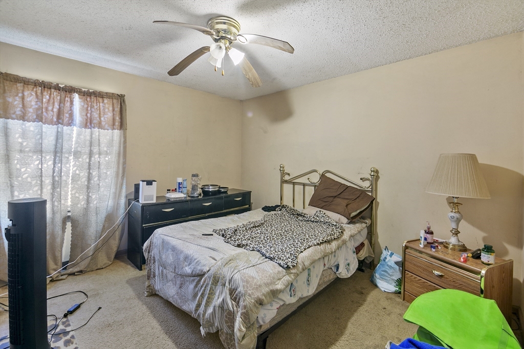 110 Tilton Street Springfield, MA 01109 - Photo 12 of 23 a bedroom with a bed and a chandelier