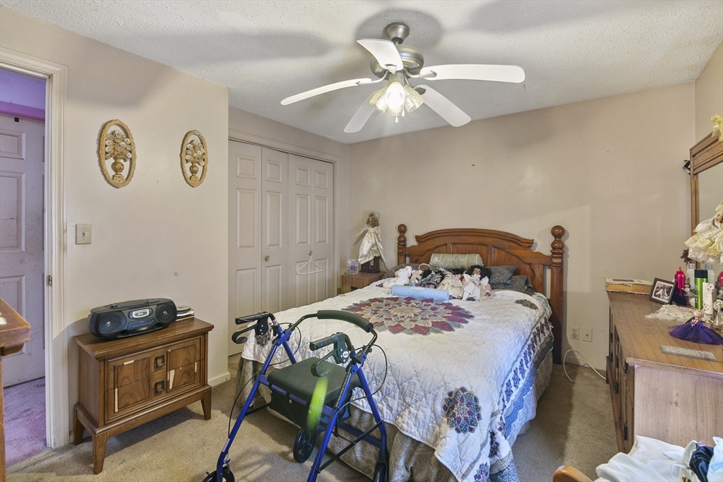 110 Tilton Street Springfield, MA 01109 - Photo 14 of 23 a bedroom with a bed and a chandelier