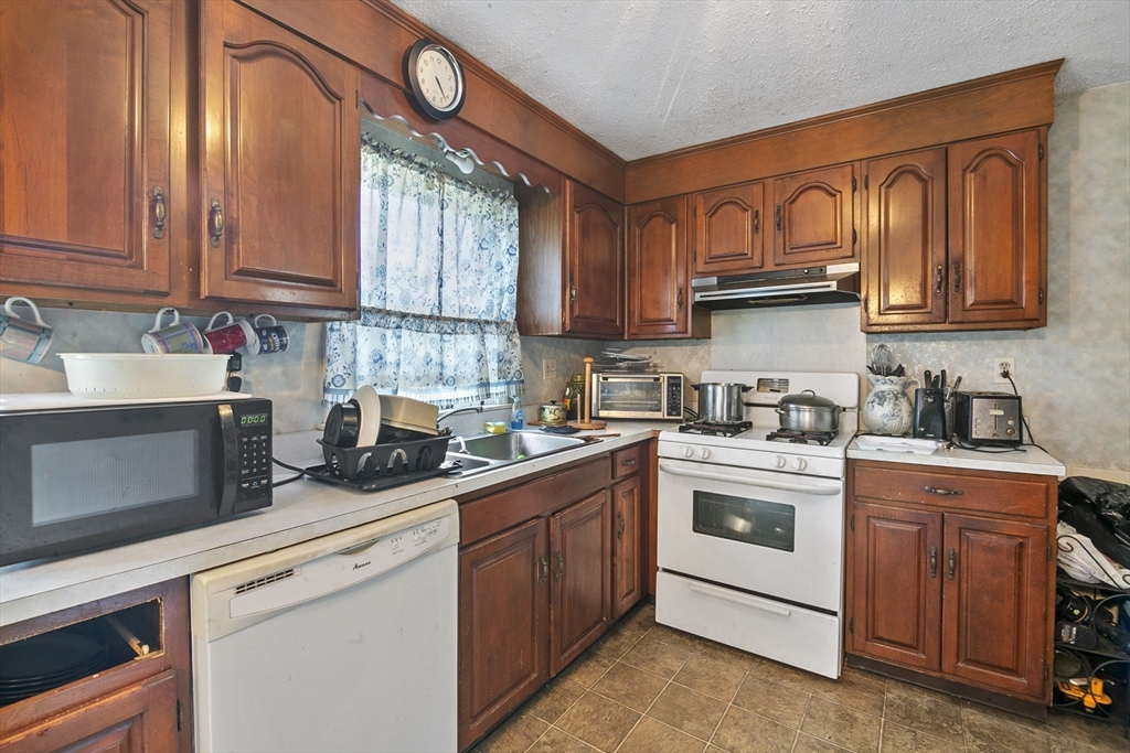 110 Tilton Street Springfield, MA 01109 - Photo 4 of 23 a kitchen with stainless steel appliances granite countertop a sink and cabinets