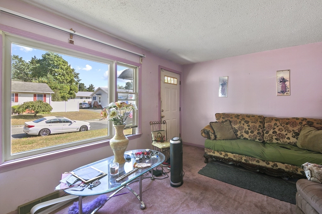 110 Tilton Street Springfield, MA 01109 - Photo 6 of 23 a living room with furniture and a large window
