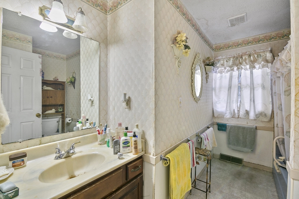 110 Tilton Street Springfield, MA 01109 - Photo 9 of 23 a bathroom with a sink mirror and a shower