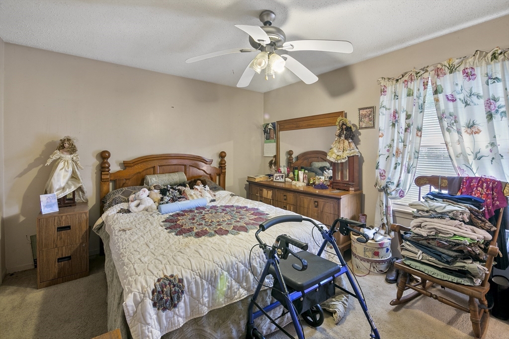 110 Tilton Street Springfield, MA 01109 - Photo 10 of 23 a bedroom with a bed and a chandelier