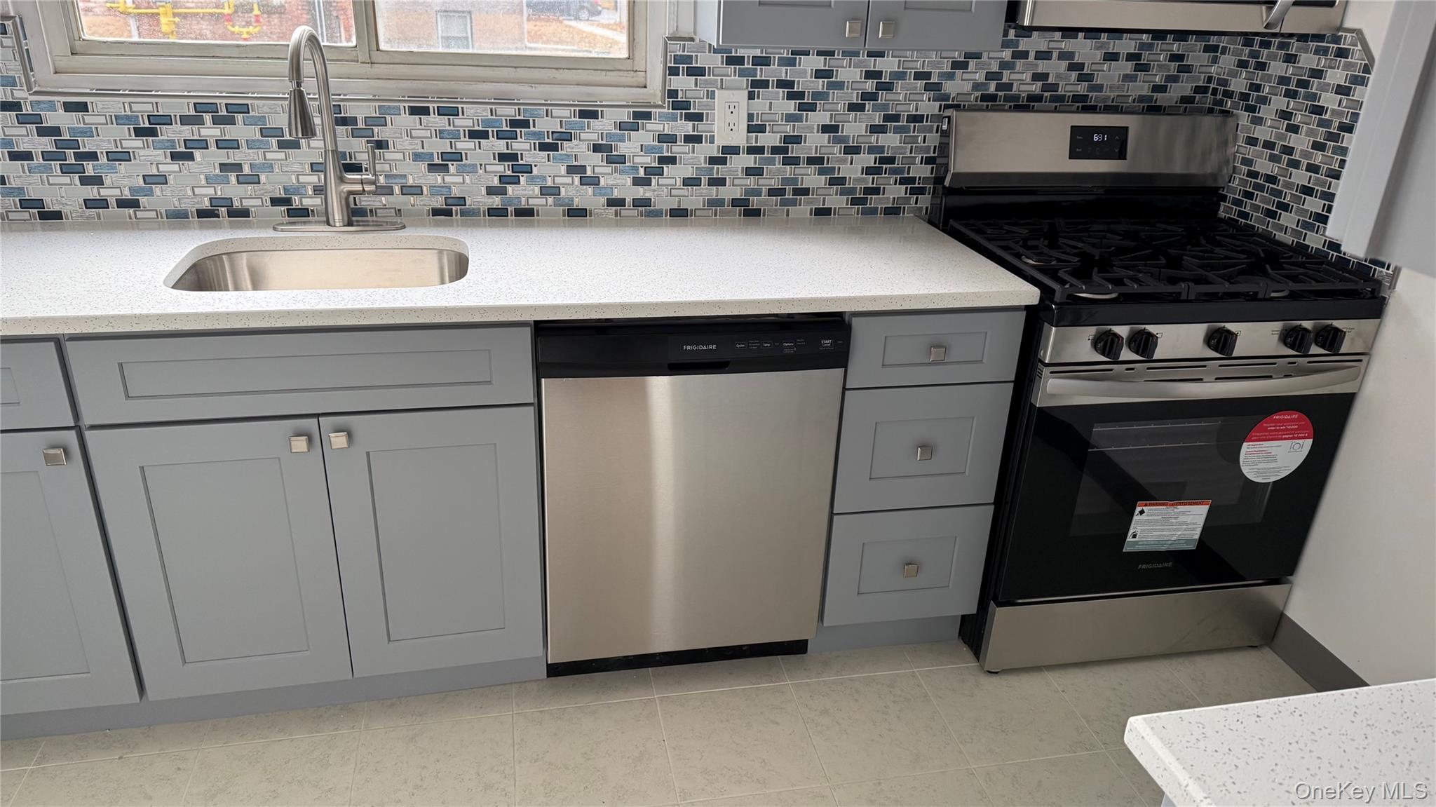 1003 Rottkamp Street, Unit 1 Valley Stream, NY 11580 - Photo 2 of 12 a kitchen with a stove and a sink