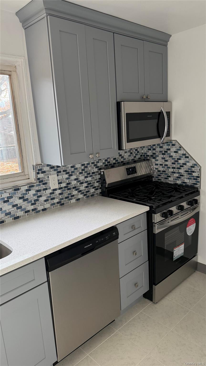 1003 Rottkamp Street, Unit 1 Valley Stream, NY 11580 - Photo 4 of 12 a kitchen with a stove and a sink