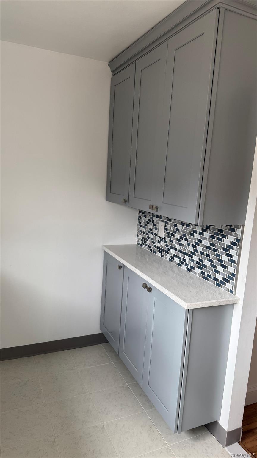 1003 Rottkamp Street, Unit 1 Valley Stream, NY 11580 - Photo 5 of 12 a kitchen with a sink and cabinets