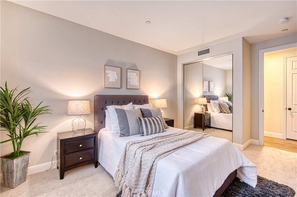 15 Tortoise Shell Coto de Caza, CA 92679 - Photo 23 of 35 a bedroom with a bed and a potted plant