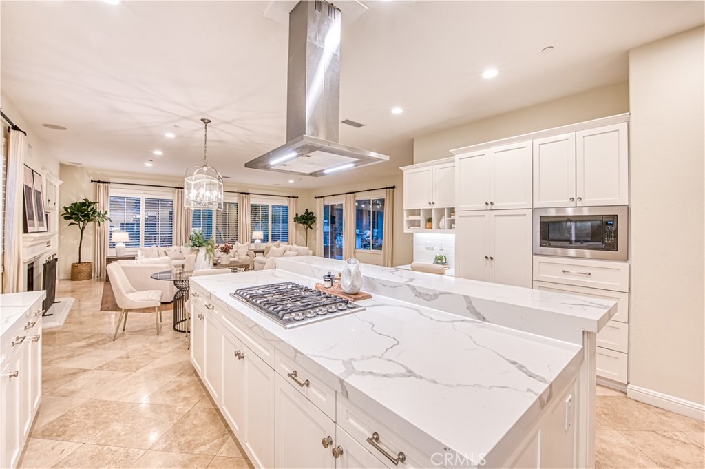 15 Tortoise Shell Coto de Caza, CA 92679 - Photo 3 of 35 a large white kitchen with a stove a sink a refrigerator and white cabinets with wooden floor