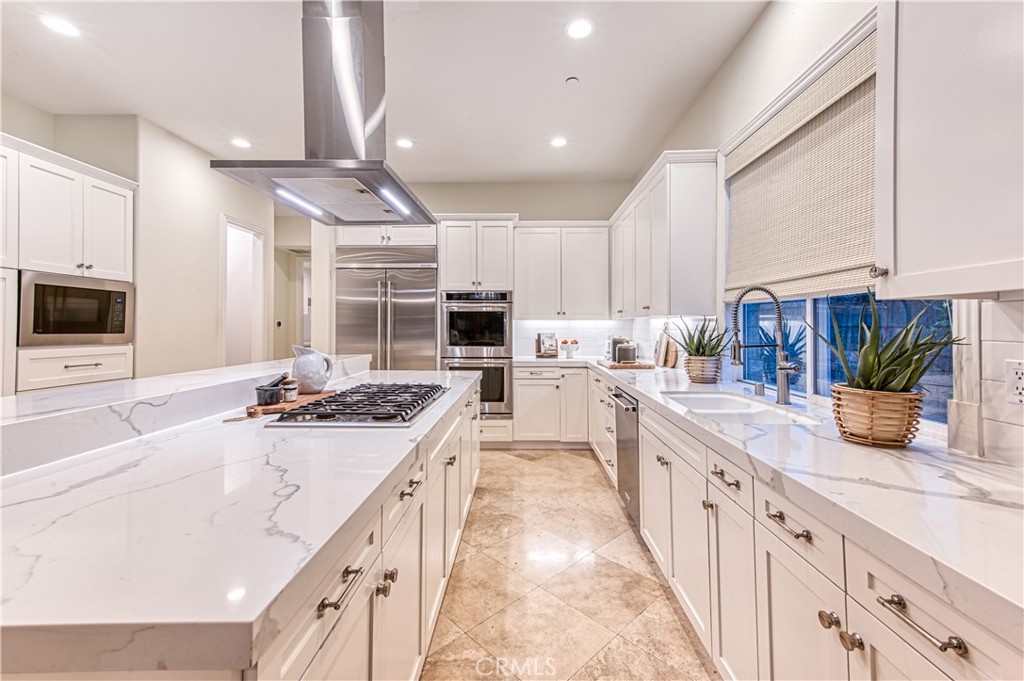 15 Tortoise Shell Coto de Caza, CA 92679 - Photo 4 of 35 a kitchen with kitchen island granite countertop a sink a counter top space stainless steel appliances and cabinets