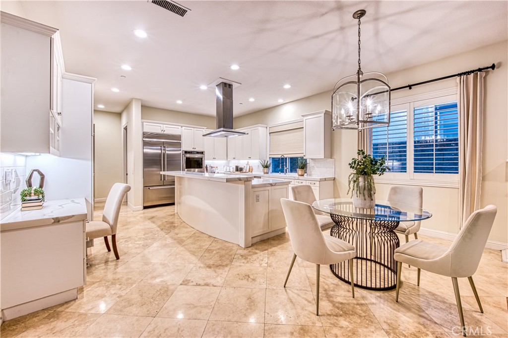 15 Tortoise Shell Coto de Caza, CA 92679 - Photo 7 of 35 a dining room kitchen with stainless steel appliances kitchen island granite countertop a dining table chairs and sink
