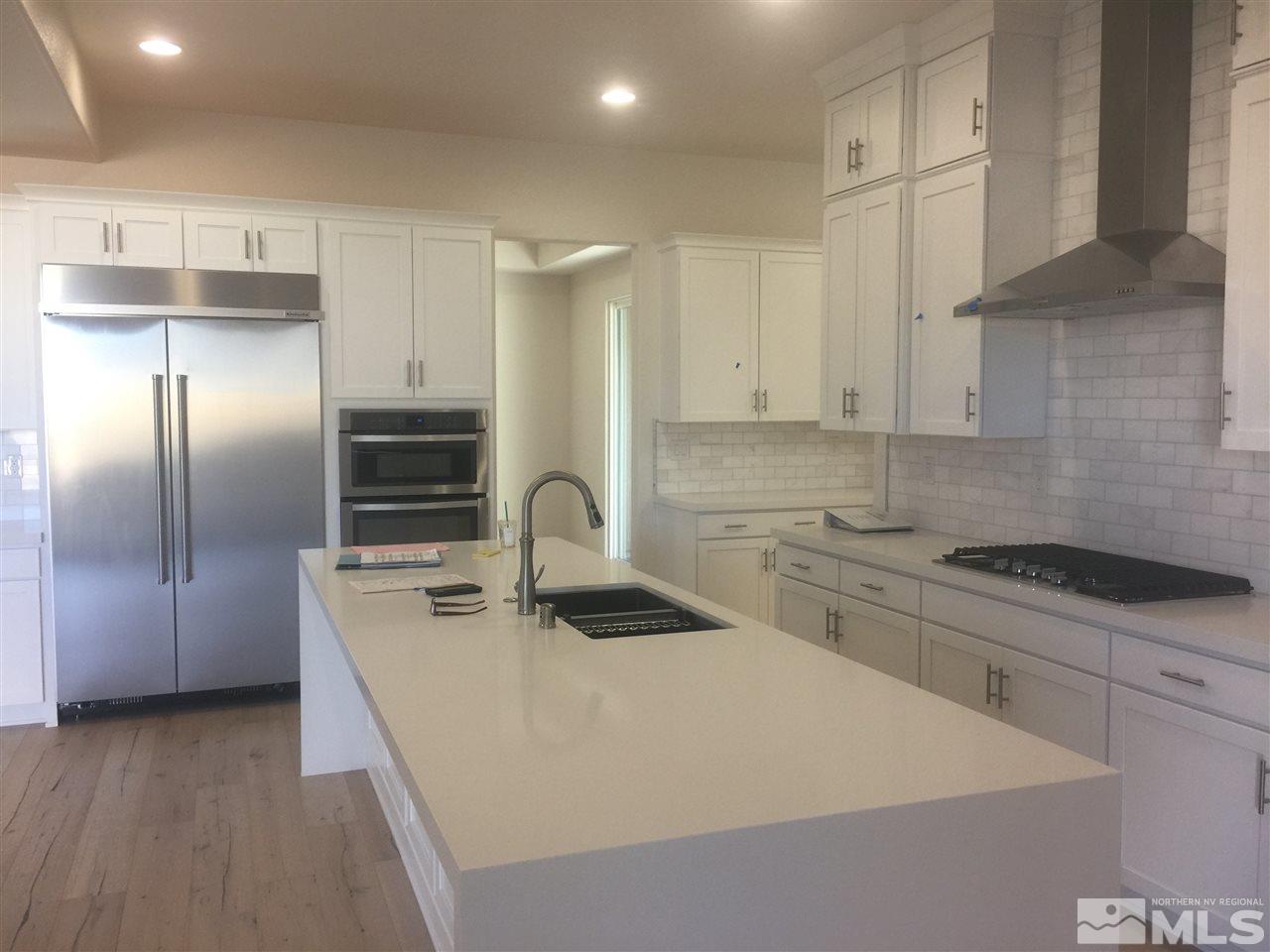 2011 Altair Lane Reno, NV 89521 - Photo 1 of 1 a kitchen with kitchen island granite countertop a sink stove and refrigerator