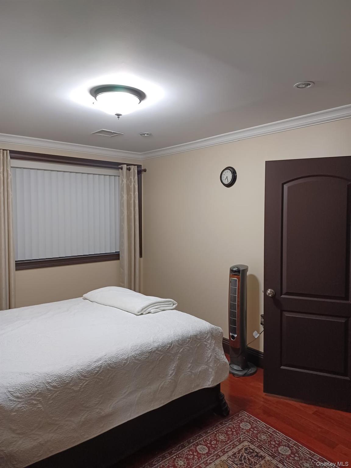 127-22 Kew Gardens Road Queens, NY 11415 - Photo 20 of 21 a bedroom with a bed and a refrigerator