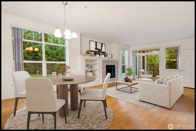a living room with furniture fireplace and a large window