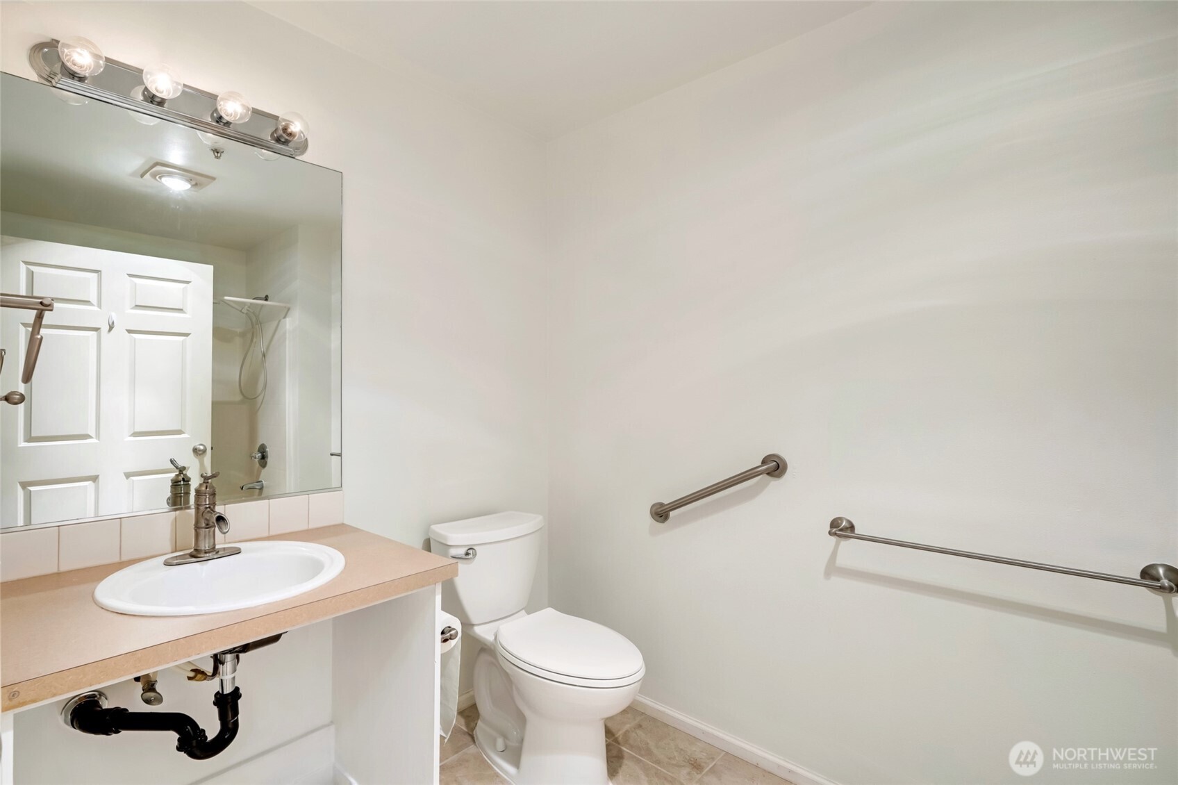 12712 Admiralty Way, Unit B101 Everett, WA 98204 - Photo 11 of 21 a bathroom with a sink toilet and a mirror