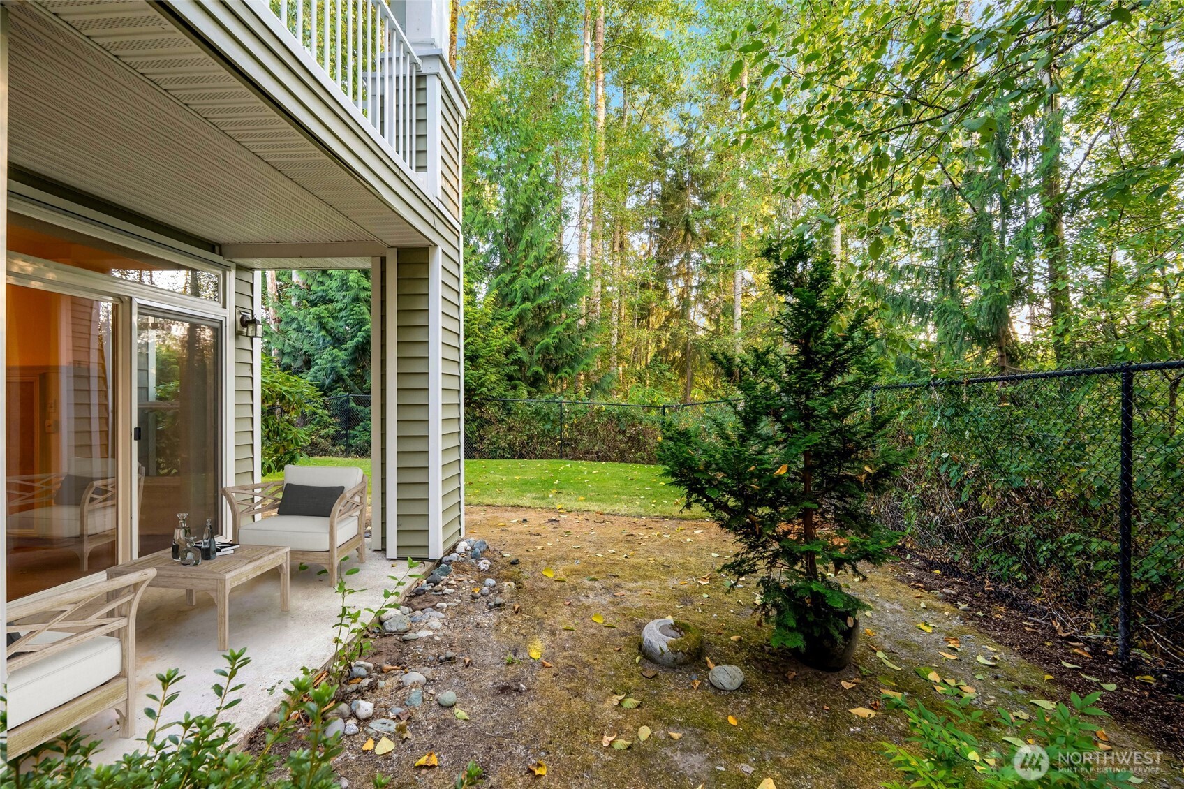 12712 Admiralty Way, Unit B101 Everett, WA 98204 - Photo 15 of 21 a view of a yard with potted plants and large tree