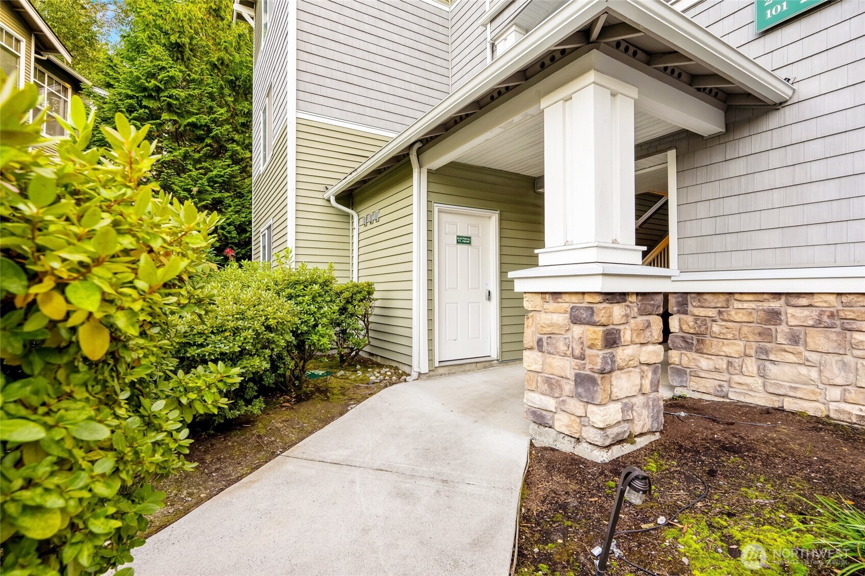 12712 Admiralty Way, Unit B101 Everett, WA 98204 - Photo 17 of 21 a front view of a house with garden