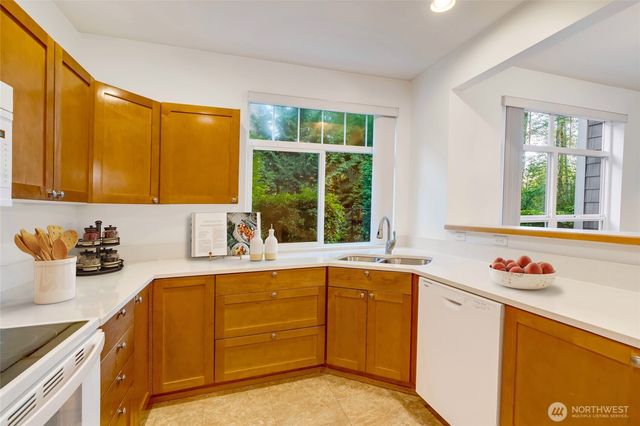 a kitchen with a stove microwave and sink