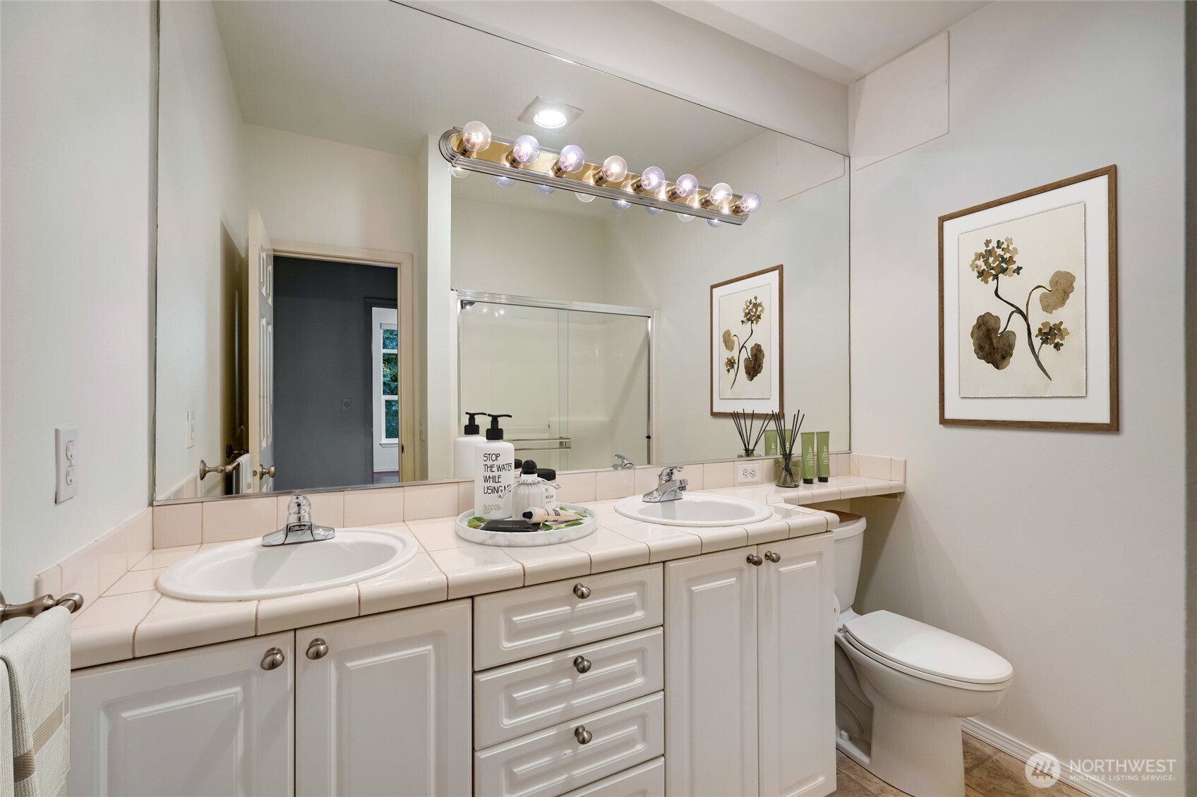 12712 Admiralty Way, Unit B101 Everett, WA 98204 - Photo 7 of 21 a bathroom with a sink toilet and a mirror