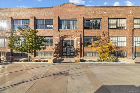 a front view of a building with glass windows and ceiling fan