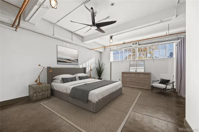 a bedroom with a bed couch and a window