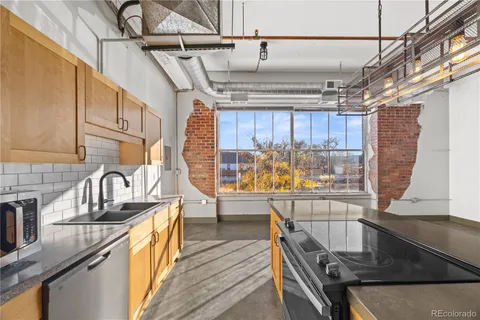 a view of a kitchen with furniture and wooden floor
