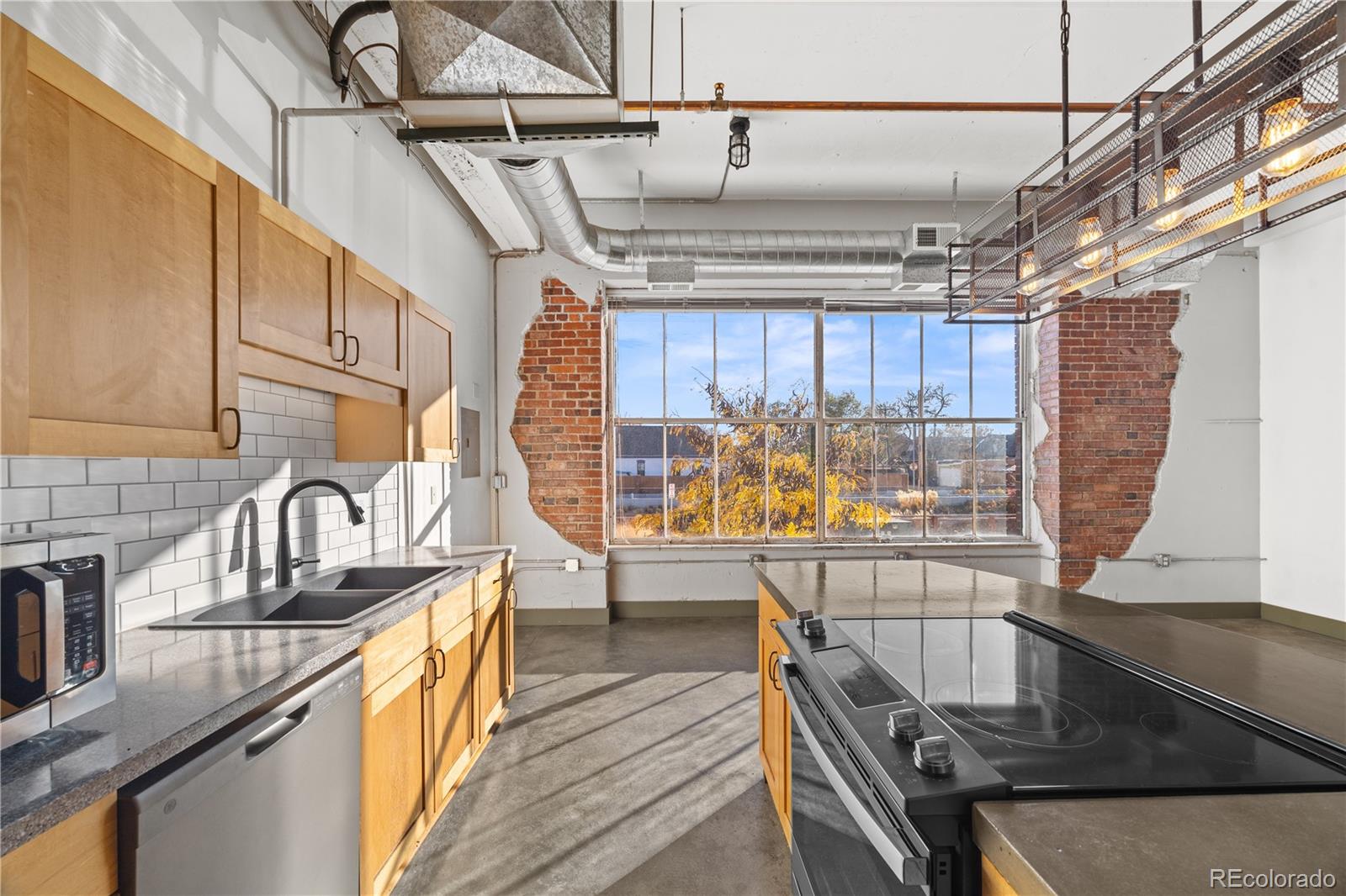 1777 East 39th Avenue, Unit 205 Denver, CO 80205 - Photo 5 of 13 a view of a kitchen with furniture and wooden floor