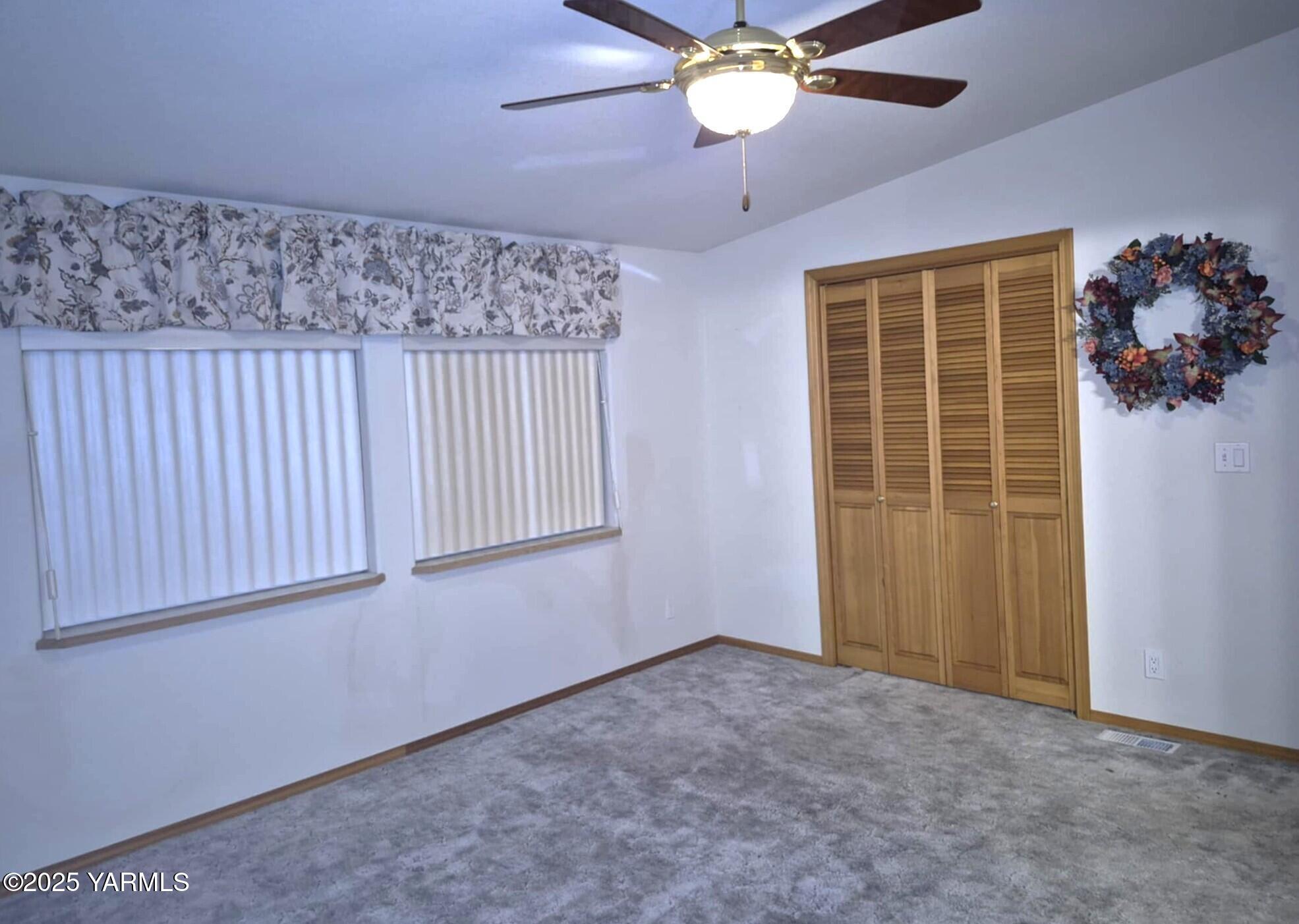 2490 Thompson Road Cowiche, WA 98923 - Photo 42 of 62 an empty room with a ceiling fan and a window