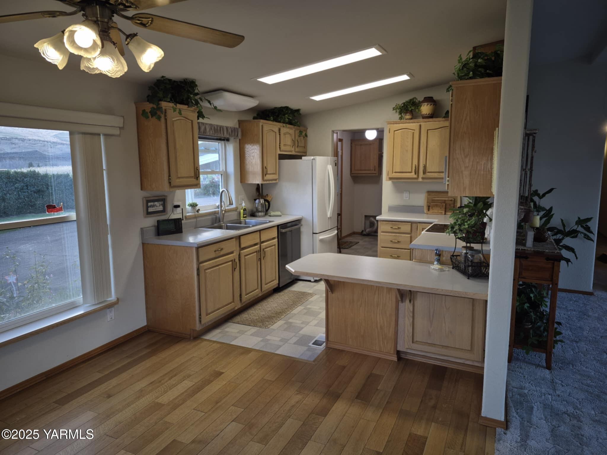 2490 Thompson Road Cowiche, WA 98923 - Photo 49 of 62 a kitchen with stainless steel appliances granite countertop a sink cabinets and wooden floor