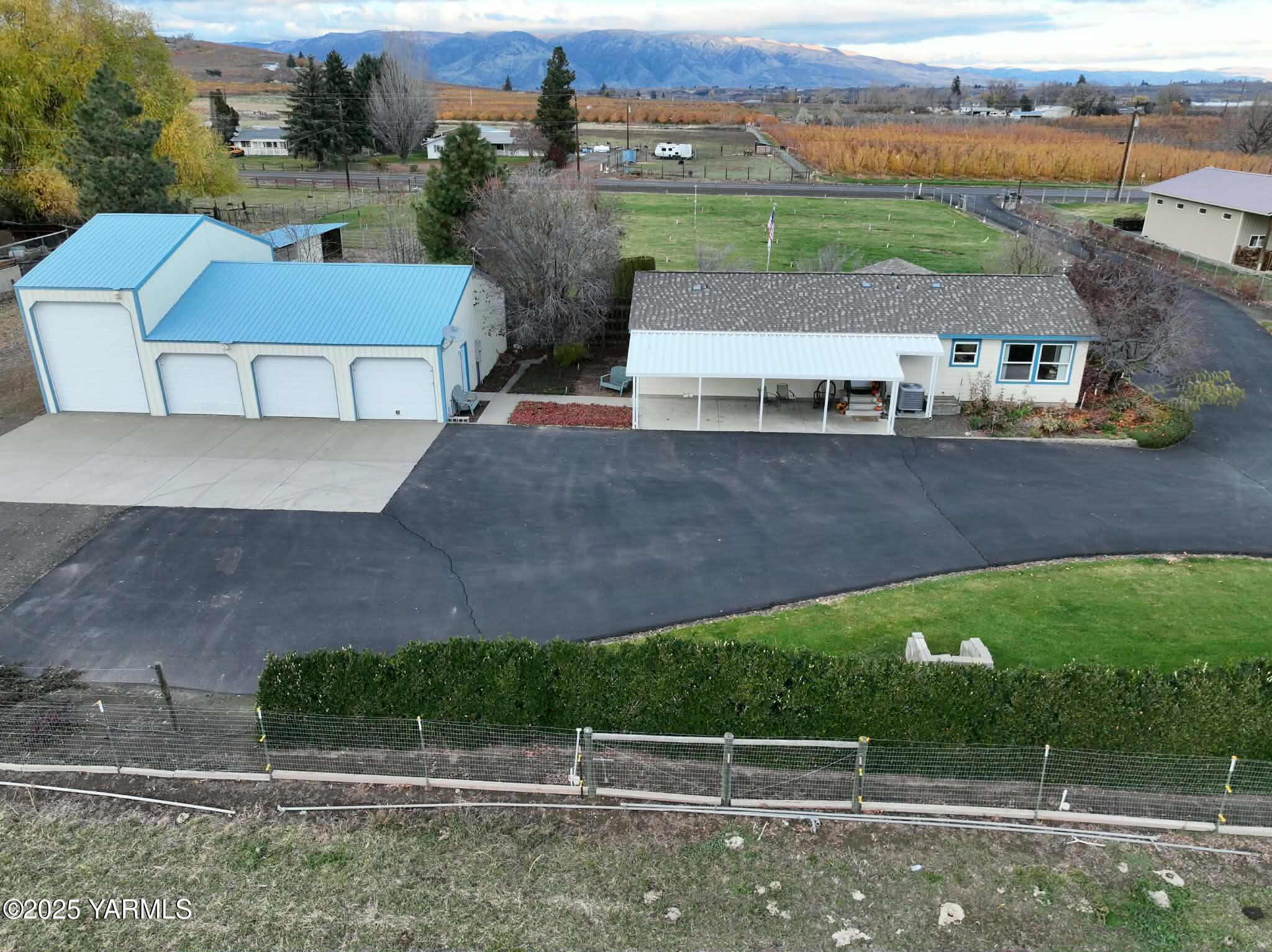 2490 Thompson Road Cowiche, WA 98923 - Photo 5 of 62 an aerial view of a house with a garden and lake view