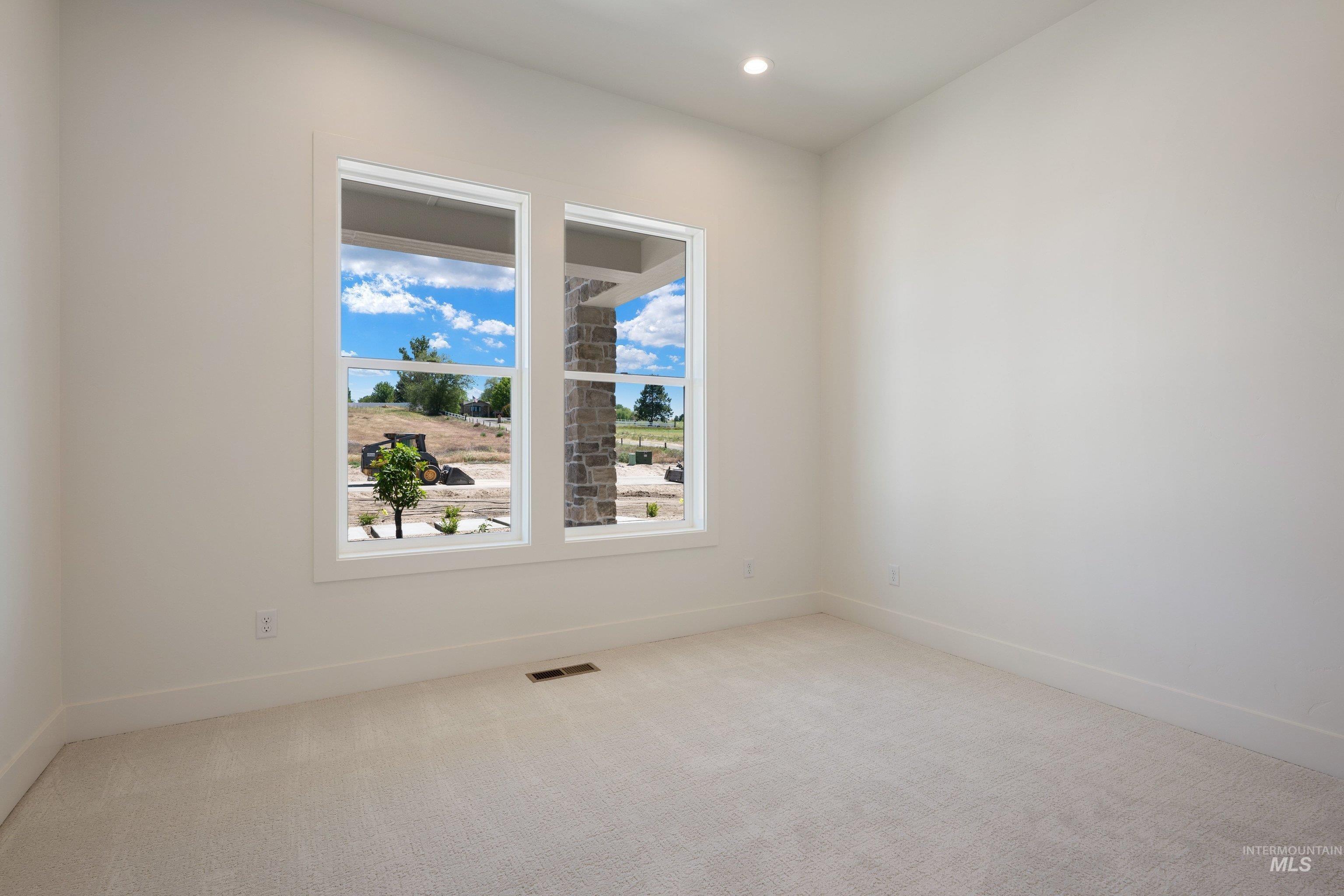24821 Ardmore Court Caldwell, ID 83607 - Photo 26 of 43 Bright interior space featuring light-colored carpet flooring and white baseboards