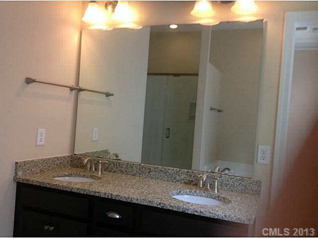 78026 Rillstone Drive, Unit 186 Lancaster, SC 29720 - Photo 12 of 13 a bathroom with a granite countertop sink and a mirror