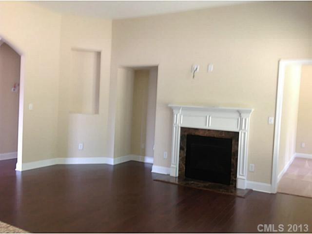 78026 Rillstone Drive, Unit 186 Lancaster, SC 29720 - Photo 10 of 13 a view of a livingroom with wooden floor and a fireplace