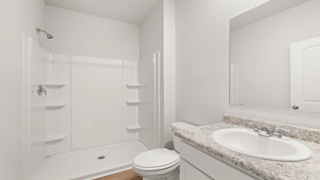 101 Hill Side Road Dallas, GA 30157 - Photo 13 of 31 a bathroom with a granite countertop sink toilet mirror and shower