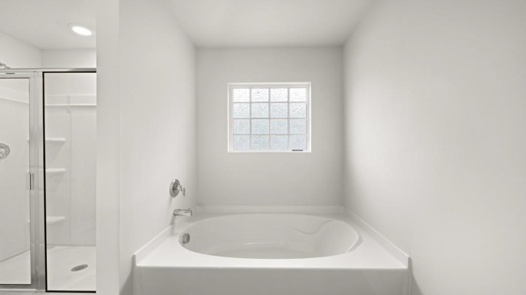 101 Hill Side Road Dallas, GA 30157 - Photo 18 of 31 a white bath tub sitting next to a window