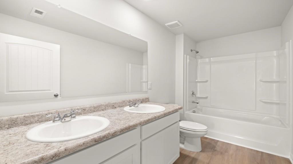 101 Hill Side Road Dallas, GA 30157 - Photo 26 of 31 a bathroom with a granite countertop sink toilet and shower