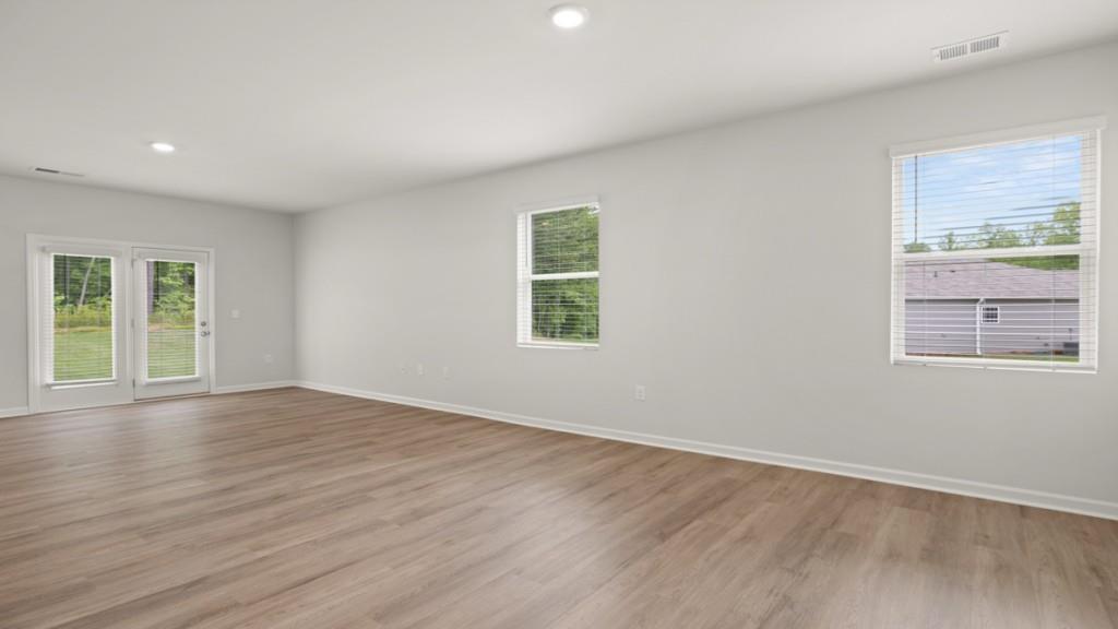 101 Hill Side Road Dallas, GA 30157 - Photo 8 of 31 a view of an empty room with wooden floor and a window