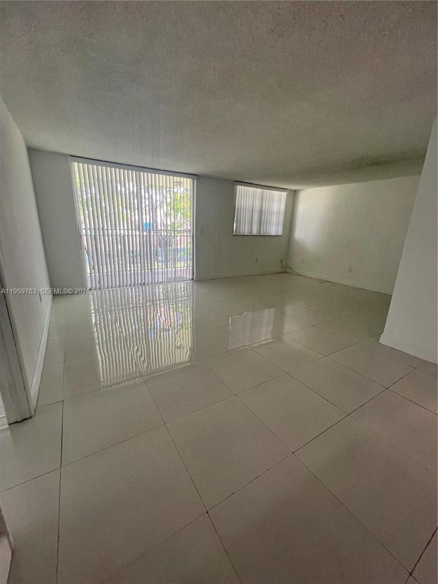 14155 Southwest 87th Street, Unit E201 Miami, FL 33183 - Photo 3 of 14 a view of an empty room with a window