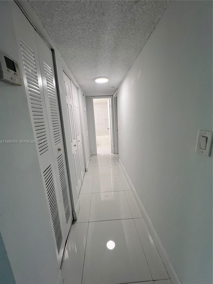 14155 Southwest 87th Street, Unit E201 Miami, FL 33183 - Photo 5 of 14 a view of hallway with stairs