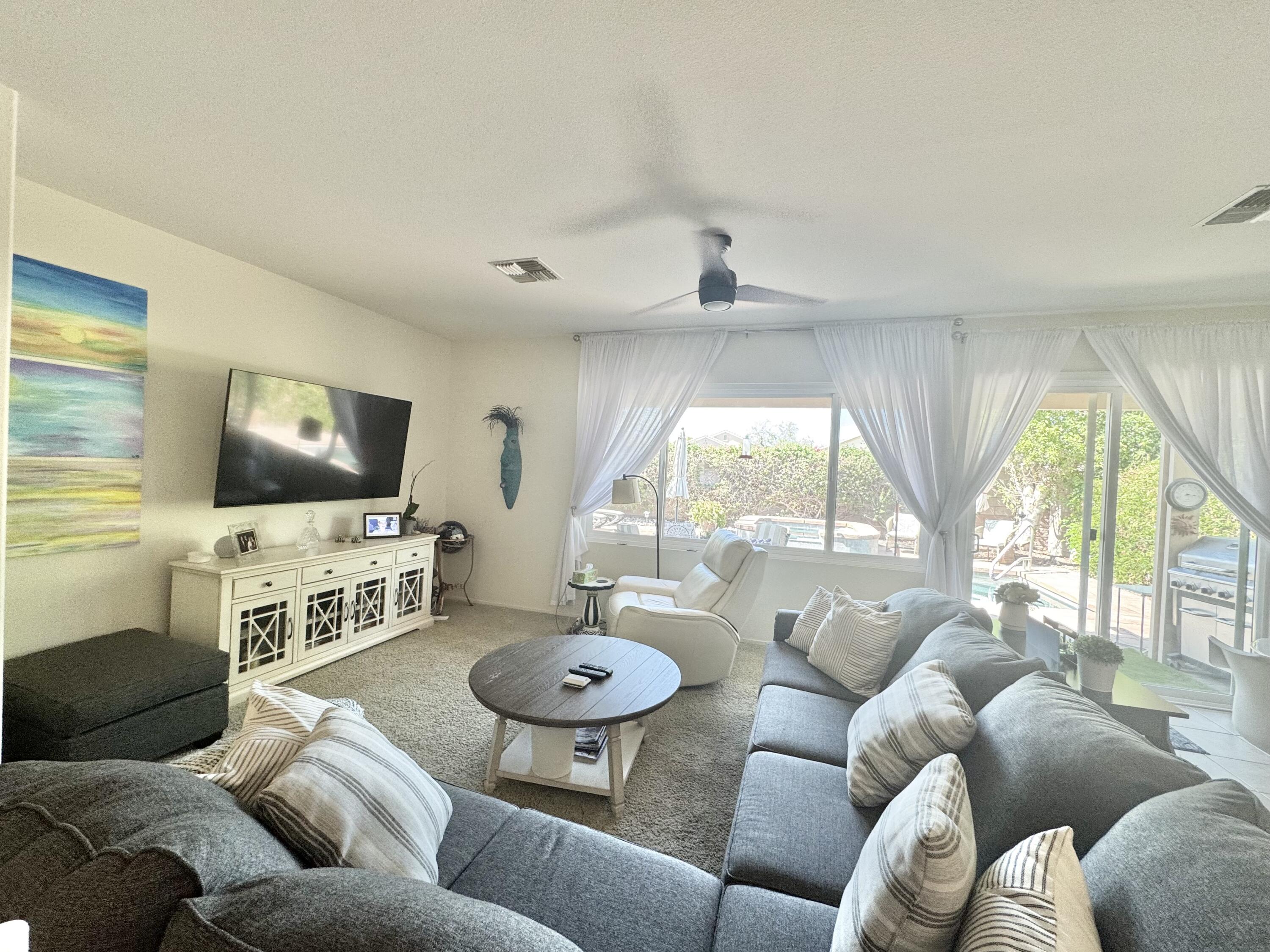 78322 Vinewood Drive Palm Desert, CA 92211 - Photo 11 of 30 a living room with furniture and a flat screen tv