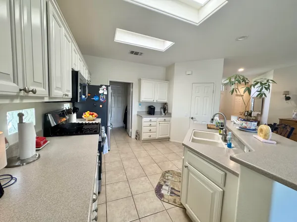 a kitchen with a sink appliances and cabinets