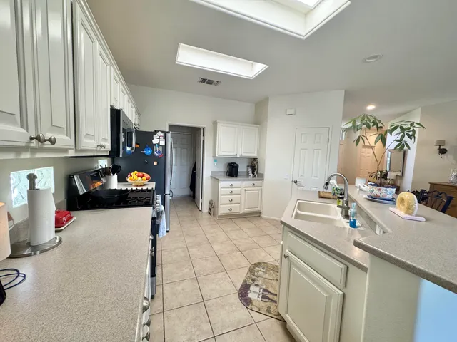 a kitchen with a sink appliances and cabinets