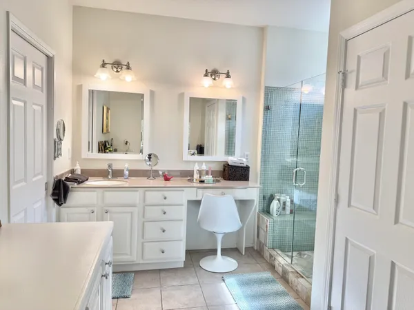 a large bathroom with a double vanity sink a mirror and a bathtub