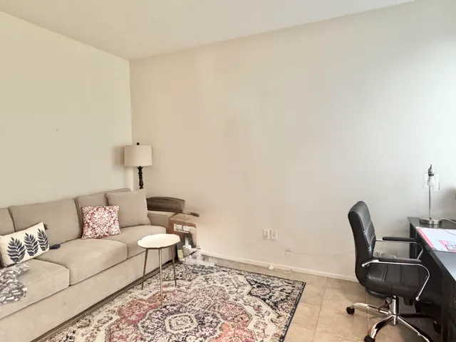 a living room with furniture and a rug