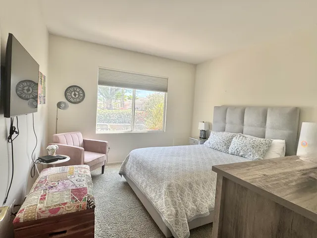 a bedroom with a bed and a window