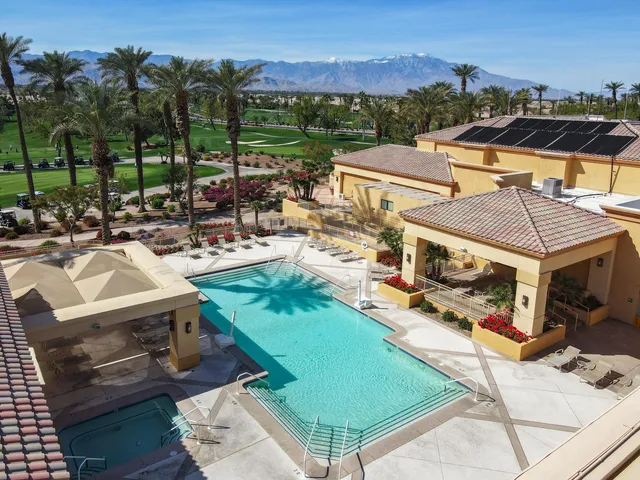 an aerial view of a house with a swimming pool and lake view