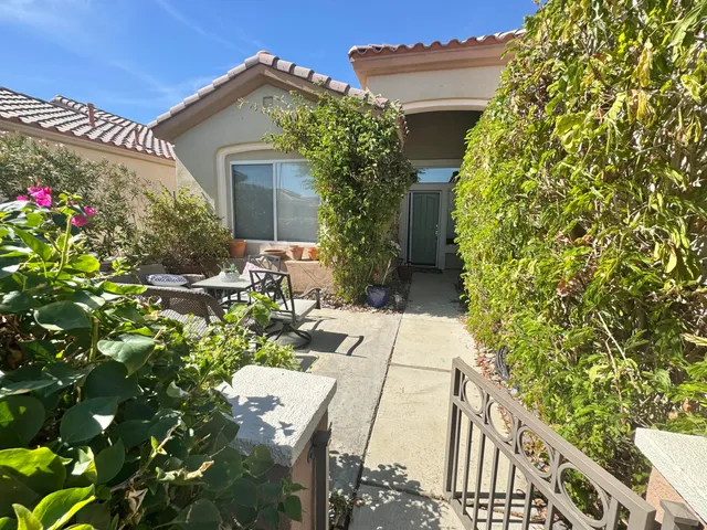 a view of a house with potted plants